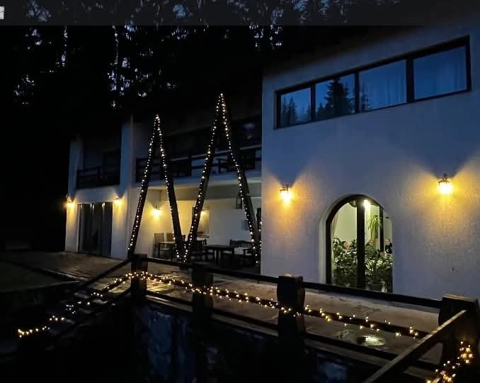 Villa — front facade in the evening with lights